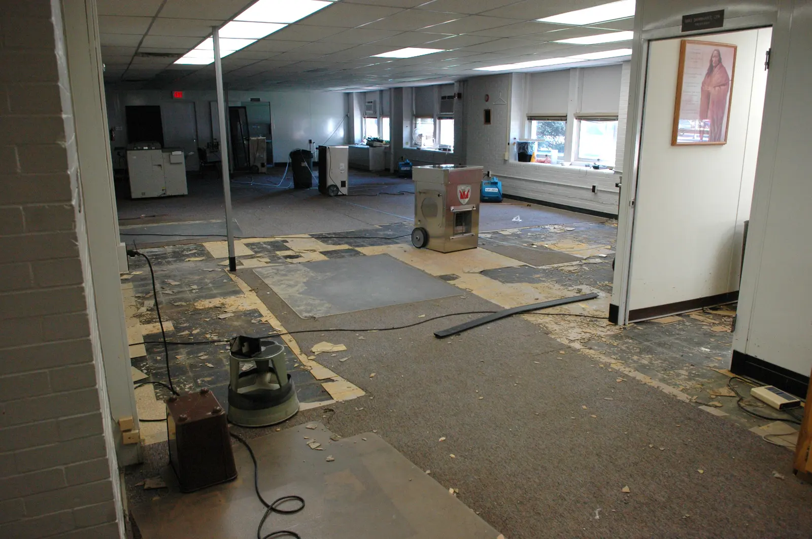 Dehumidifiers and air movers drying a water-damaged room. Shown on the homepage for Daytona Beach, FL.